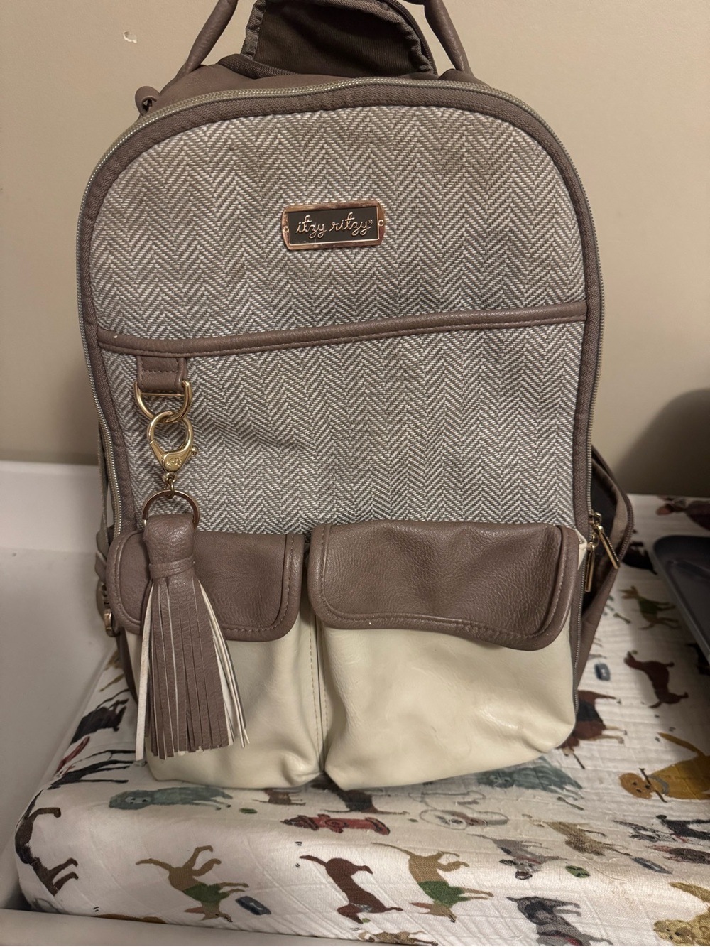 Itzy Ritzy Taupe and Cream Convertible Backpack with Tassel